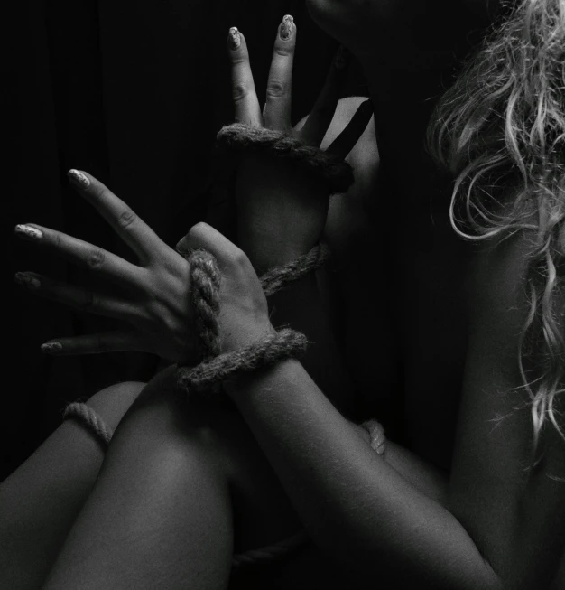 two women with their hands tied together