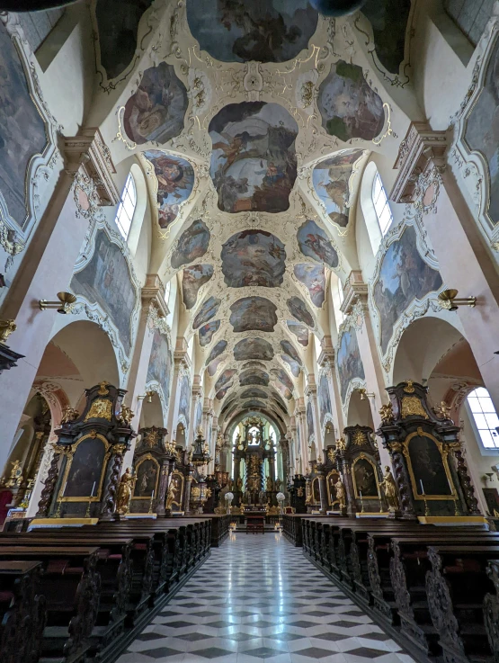 the interior of a large cathedral with painted murals