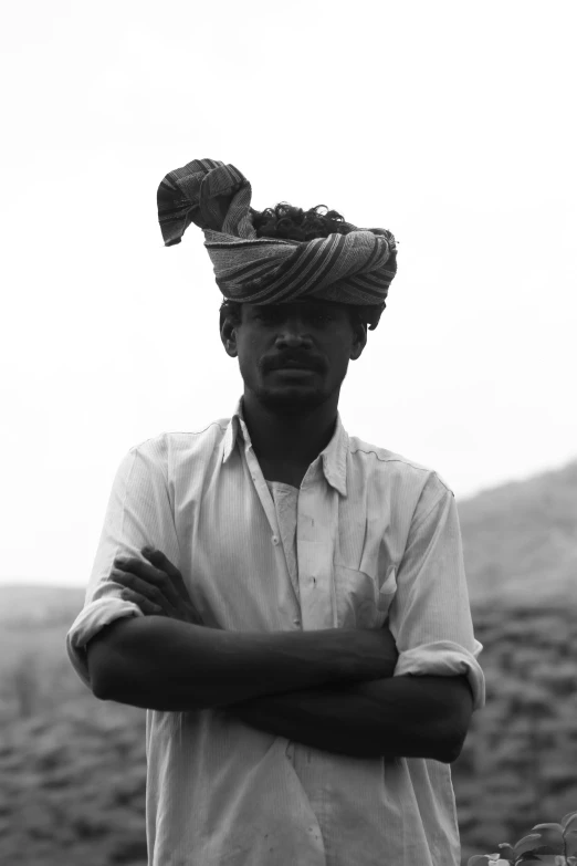 a man is standing with his hands folded