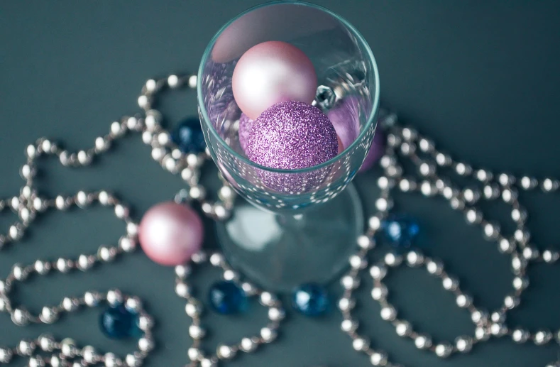 a purple and white object on a silver chain