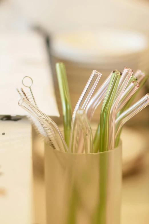 many straws in a cup on a table