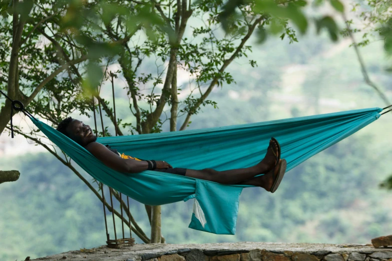 an african american woman relaxes in a hammock