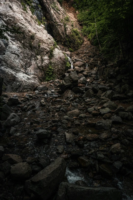 a rocky mountain with a waterfall behind it