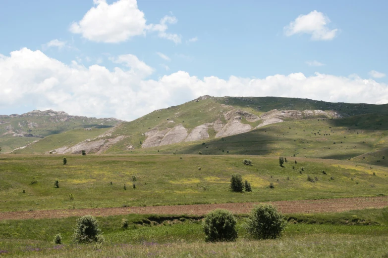 the mountain range is covered in green, brown, and gray colors