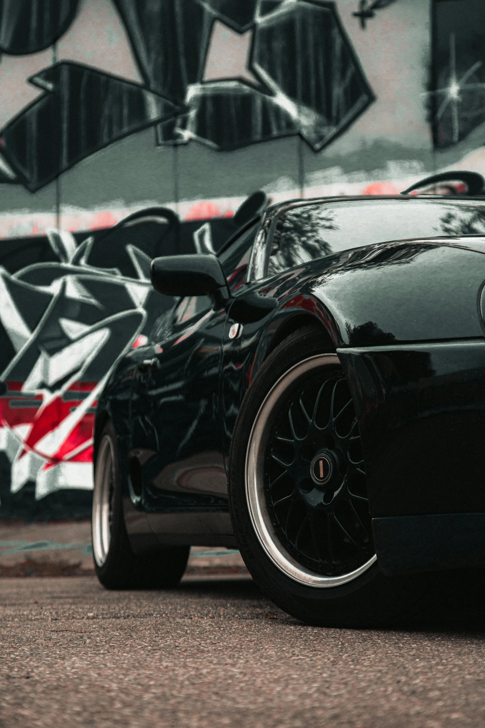 a black sports car is parked on the street