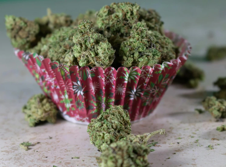 a pile of cannabis buds in a red wrapper