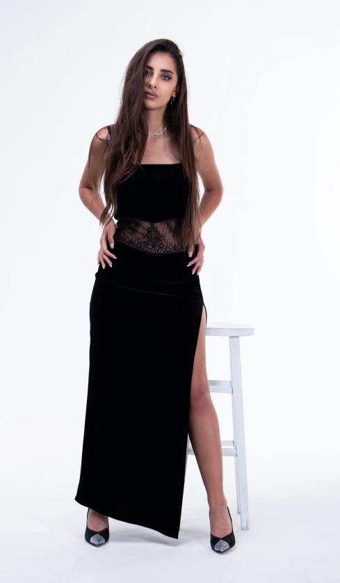 a model wears a black velvet and mesh top