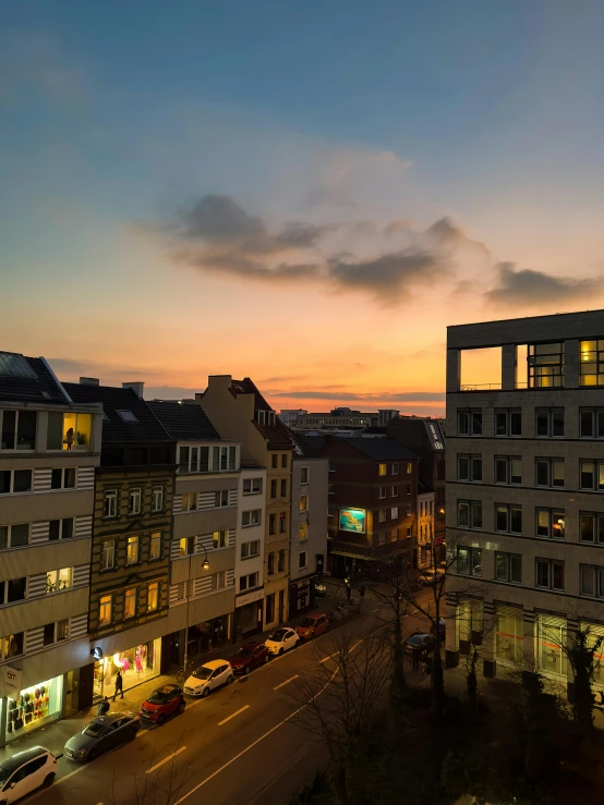 a sunset scene in a large city with street lights