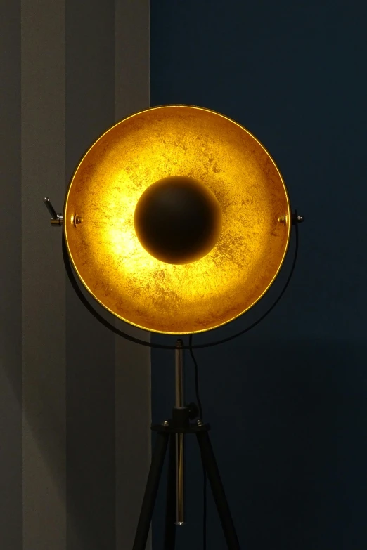 an old fashioned trombone with light up sitting on a tripod