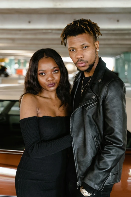 two people that are dressed in black posing together