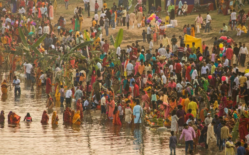 a group of people walking through the water