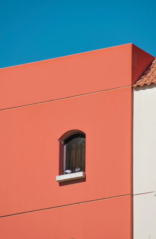 window on top of building with sky behind