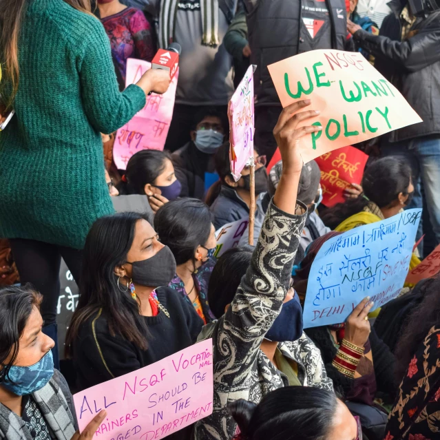 a crowd holding signs with the names of different countries