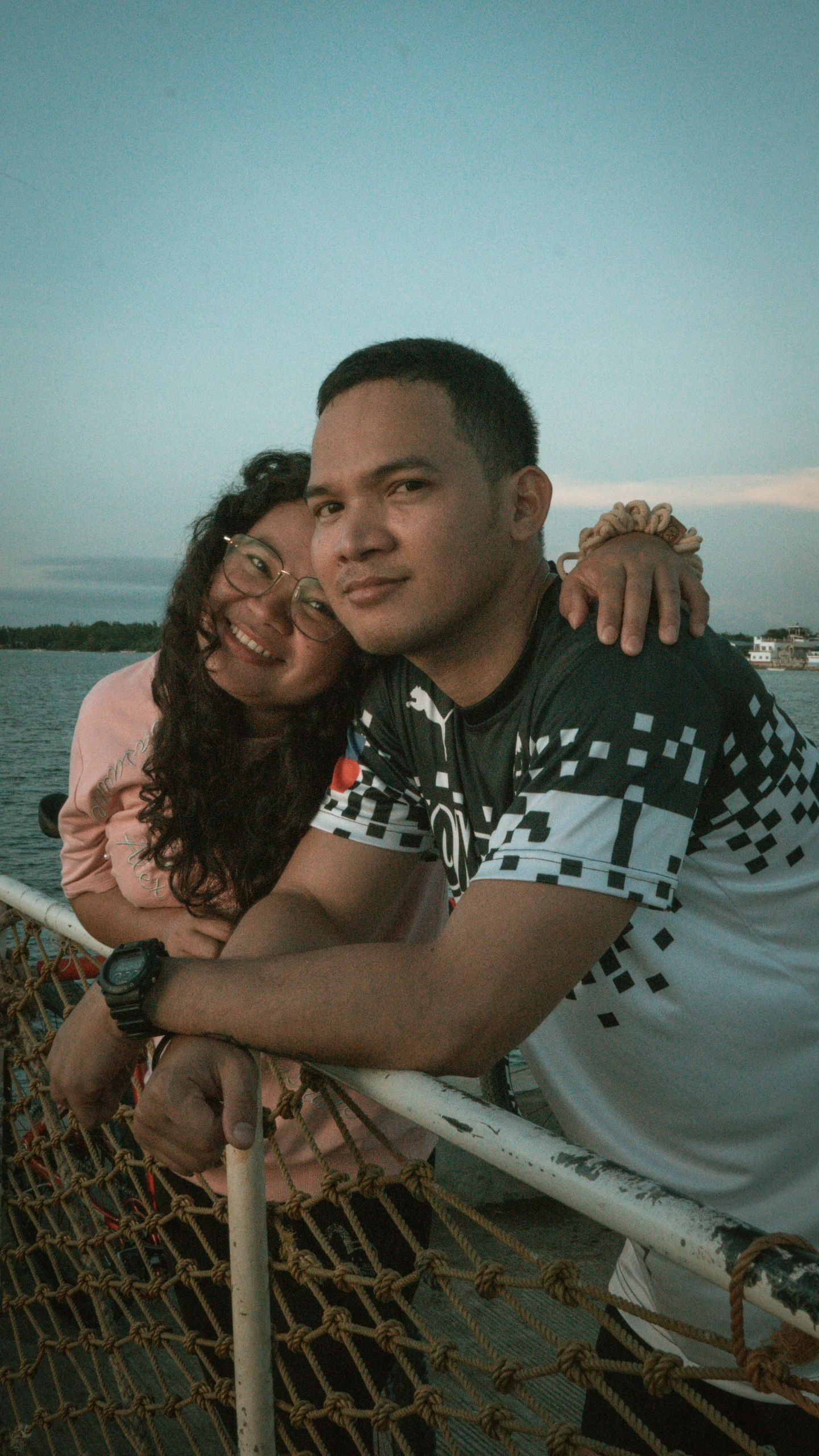 a man standing next to a woman on a boat