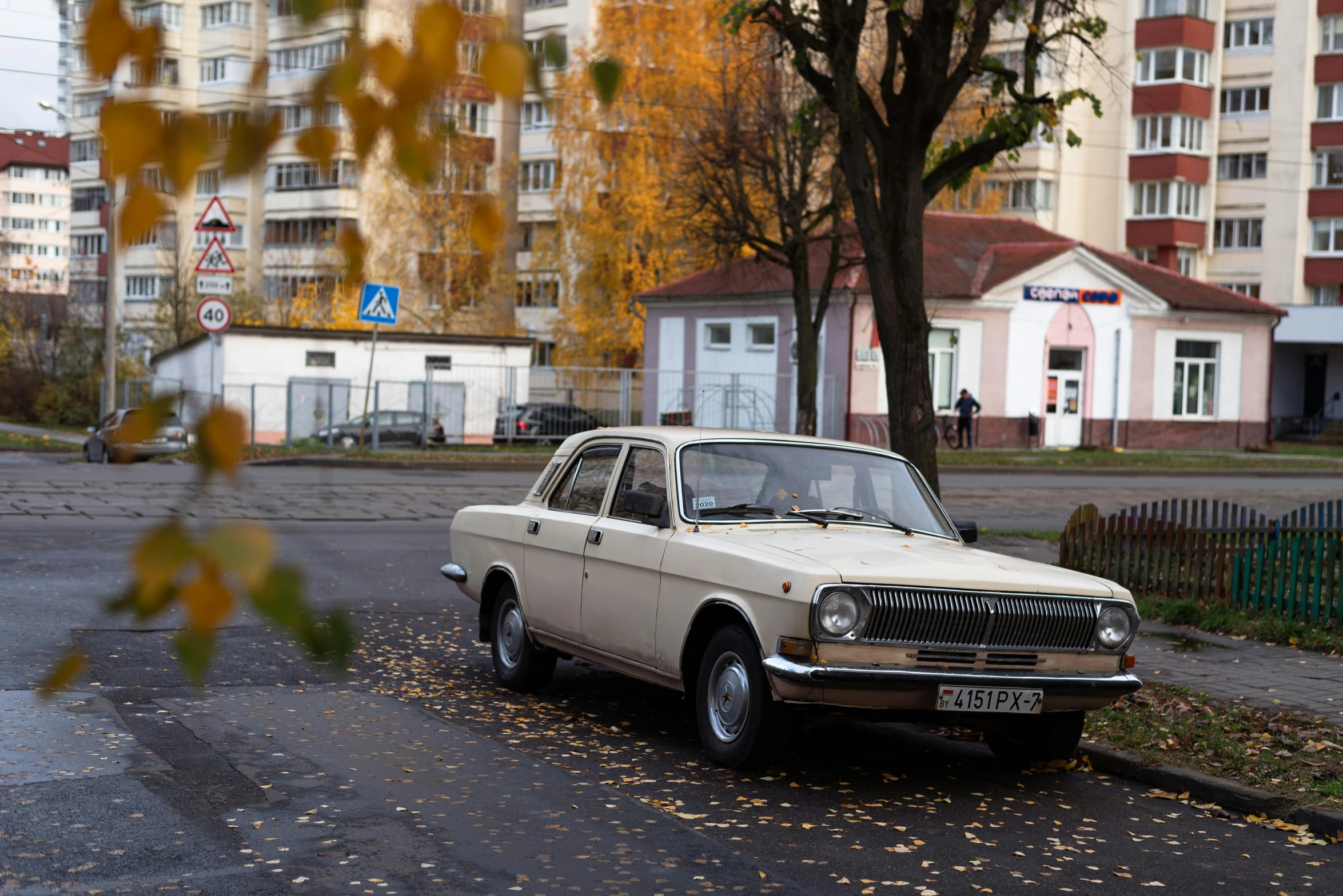 an old car parked by the side of the street