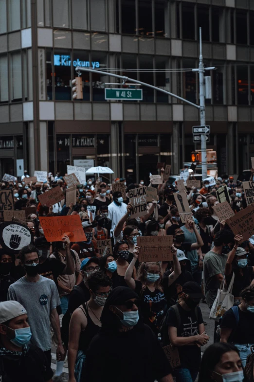 a protest in the city holding up signs