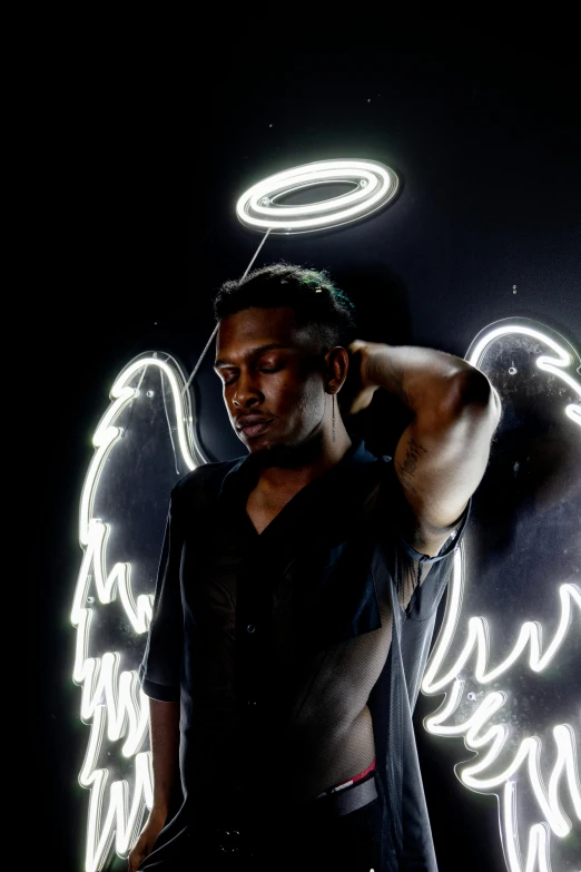 a man is posing for the camera with angel wings