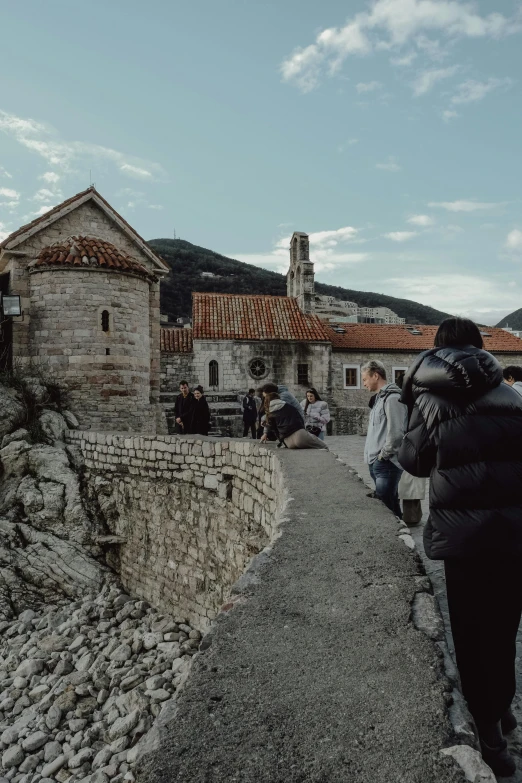 a group of people are standing around on a castle