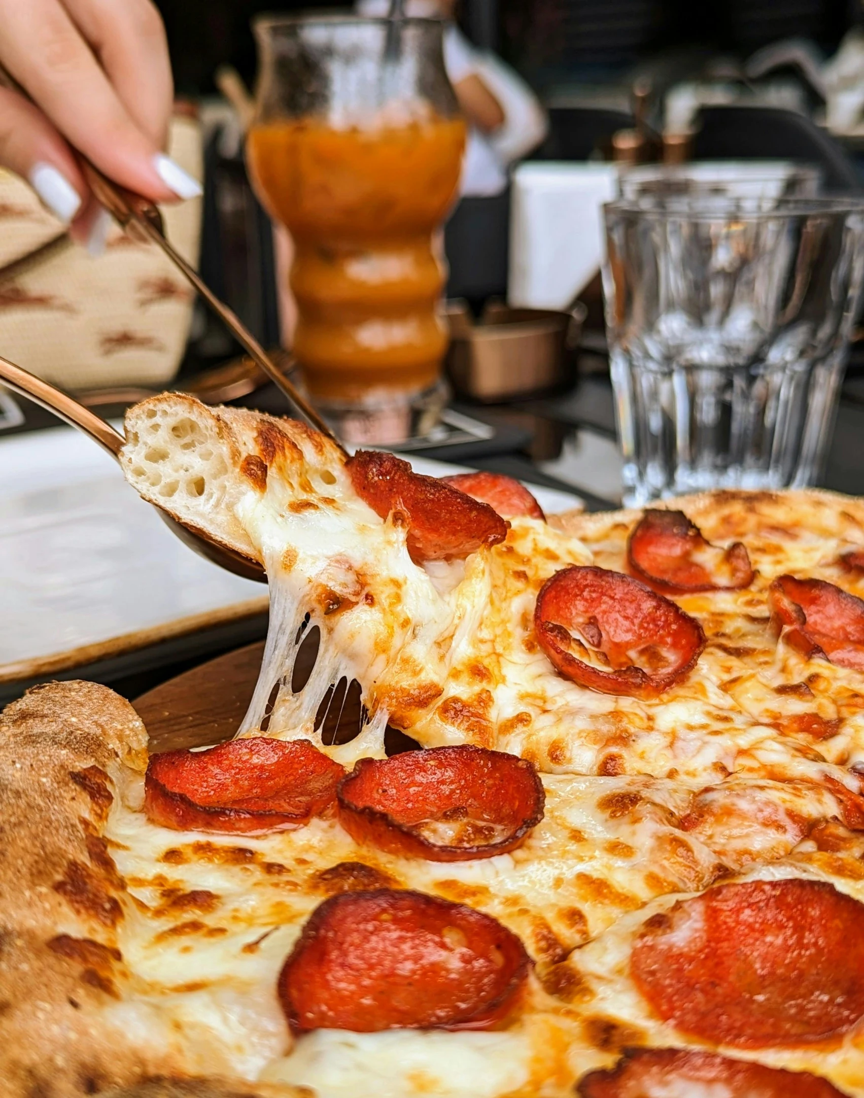 a pepperoni pizza is being held to eat