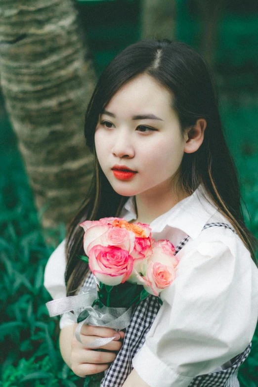 girl holding bouquet of flowers posing for a po