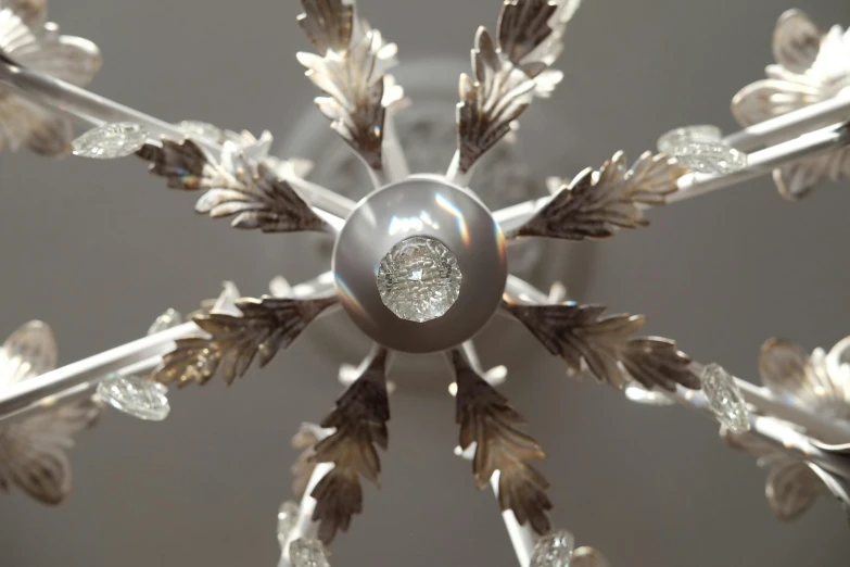 the bottom part of a chandelier with leaves, and a small round diamond