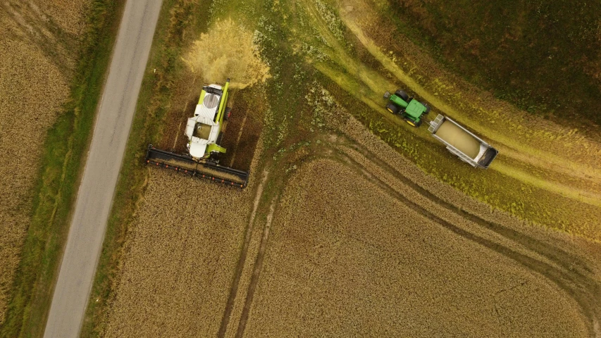 an aerial view of a field with two combiners