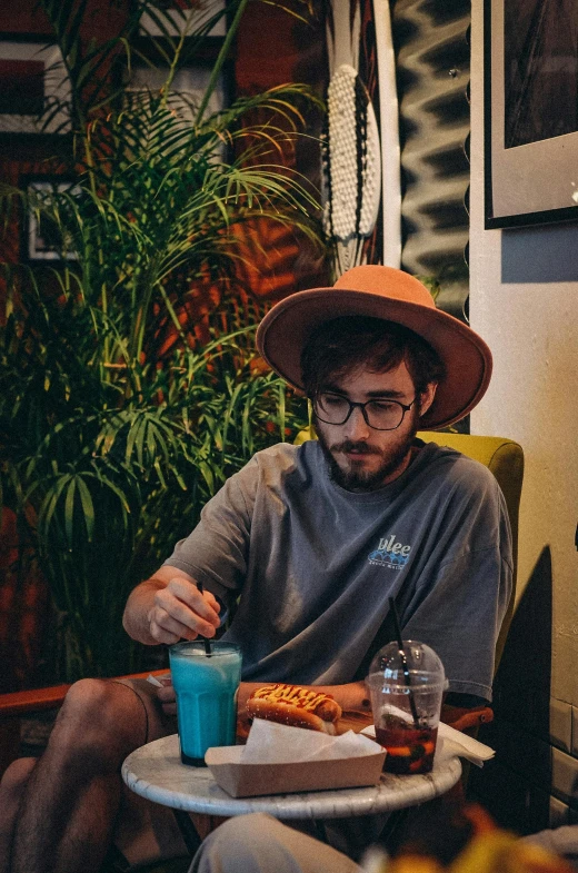 a man is eating while wearing a hat