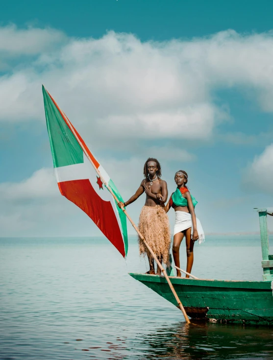 a man and woman standing on a small boat holding a flag