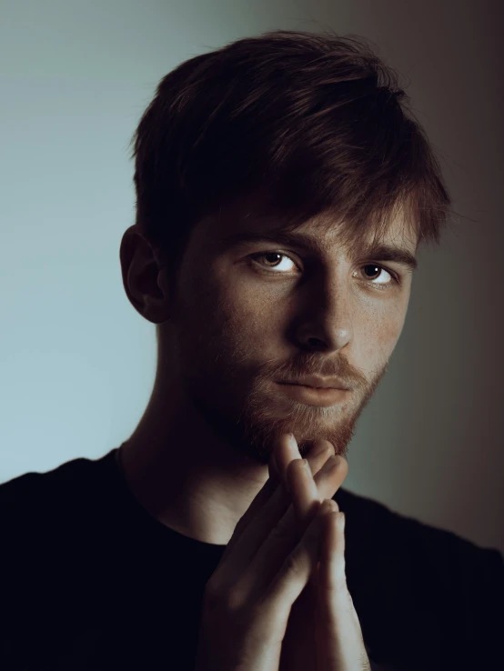 the face and shoulders of a young man