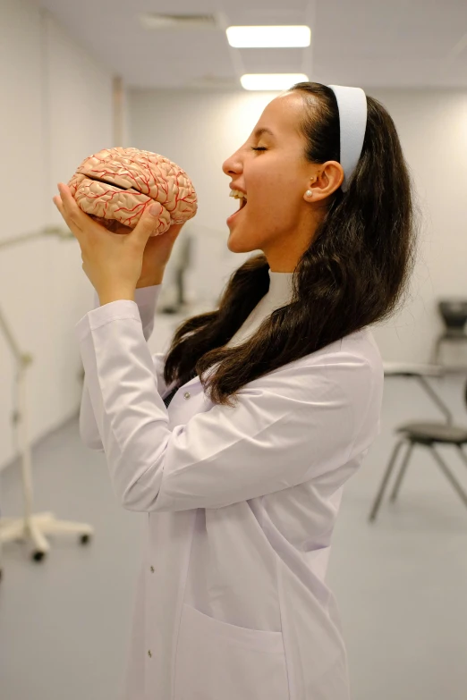 a woman with long hair holds up an object to her head