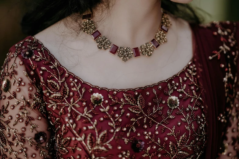 closeup view of a gold and red necklace