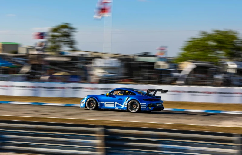 a blue car is on a race track