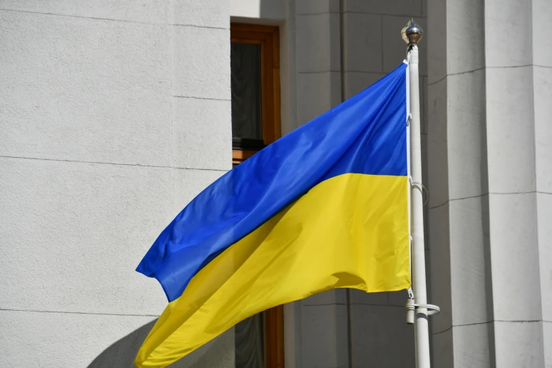 the national flag of ukraine is seen in the background