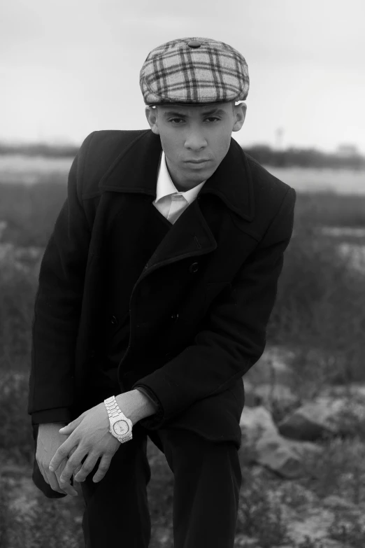 a man in suit jacket and tie with hat