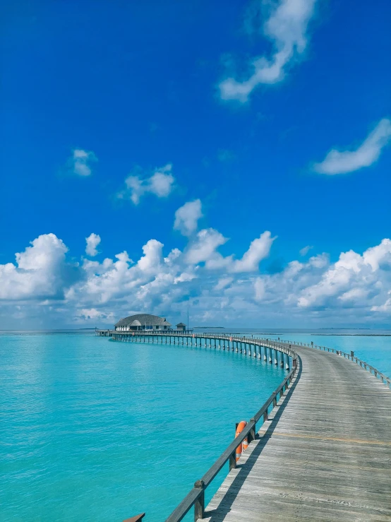 a pier that is next to the water with a wooden pier