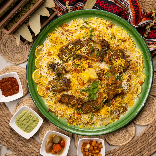 a green plate filled with lots of food on top of a table