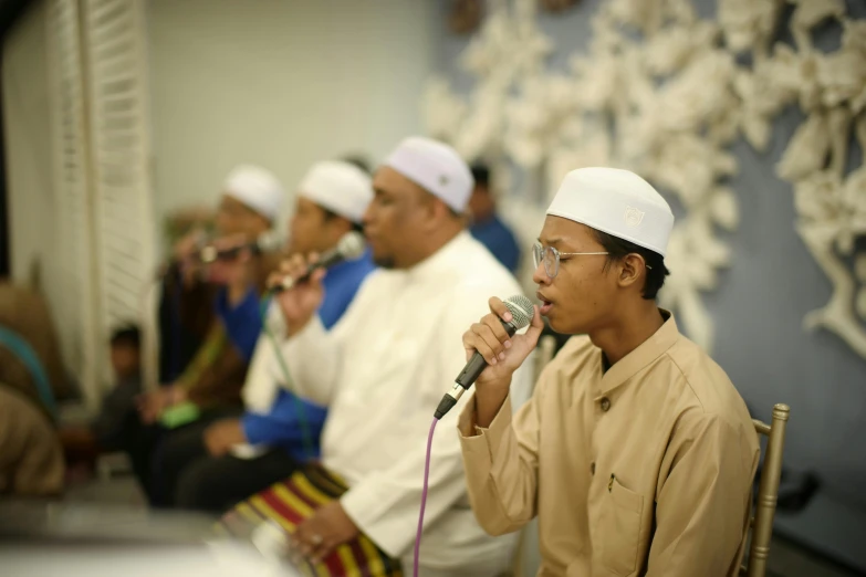 the boy is in a mosque with other men