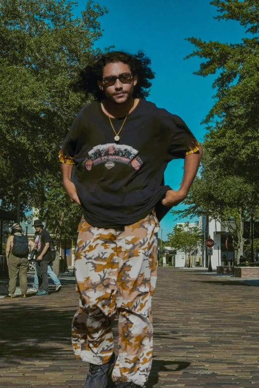 a guy is standing on the street with his skateboard