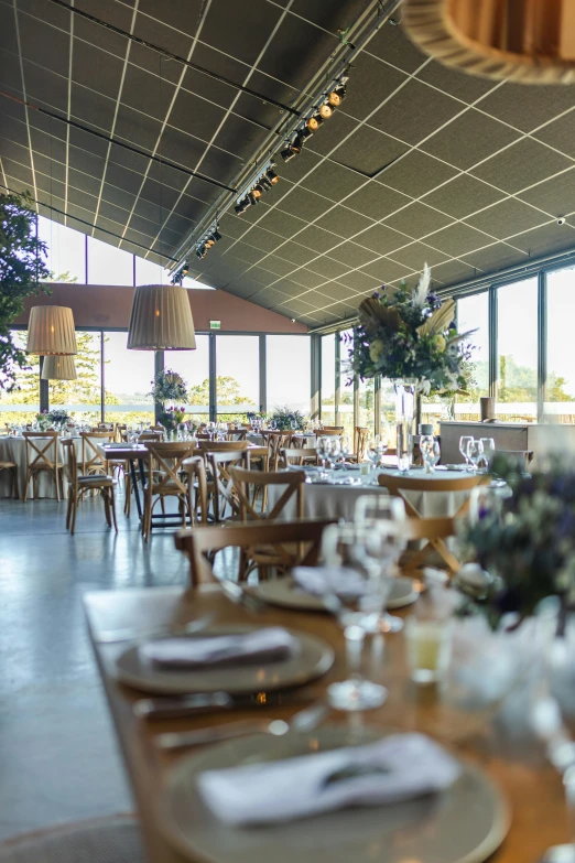 a long table and two place settings are arranged in front of a wall