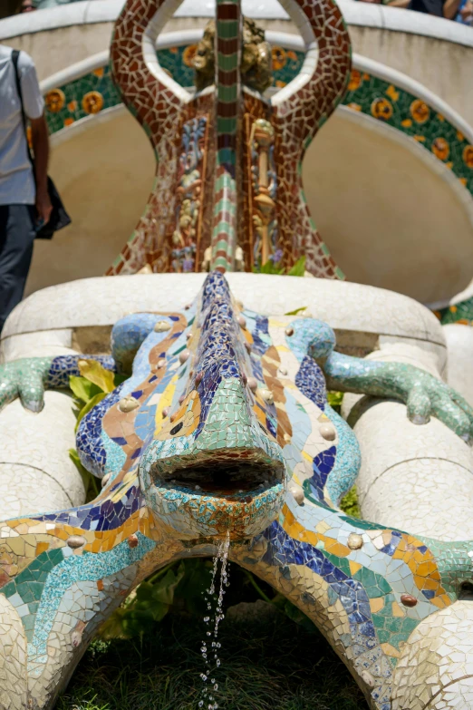 a decorative fountain with giraffes and flowers and other flowers