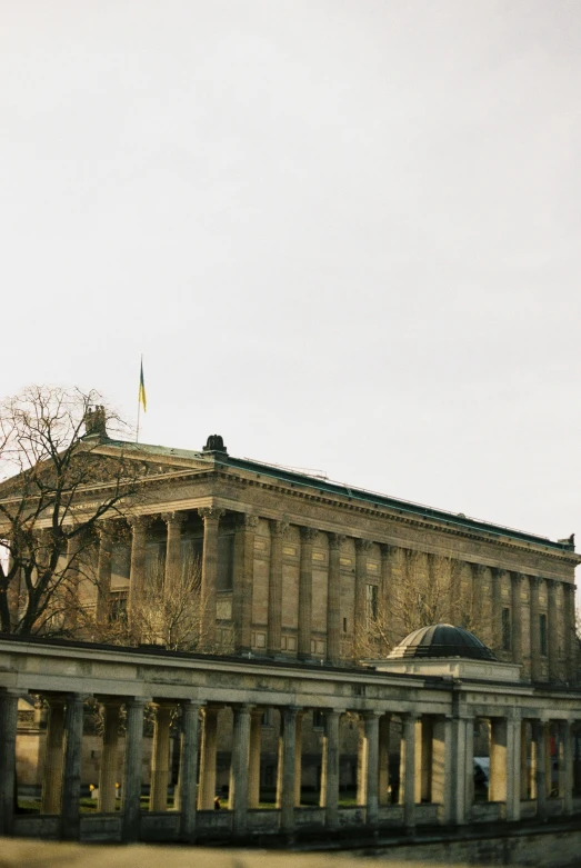 an old stone building in the middle of a street