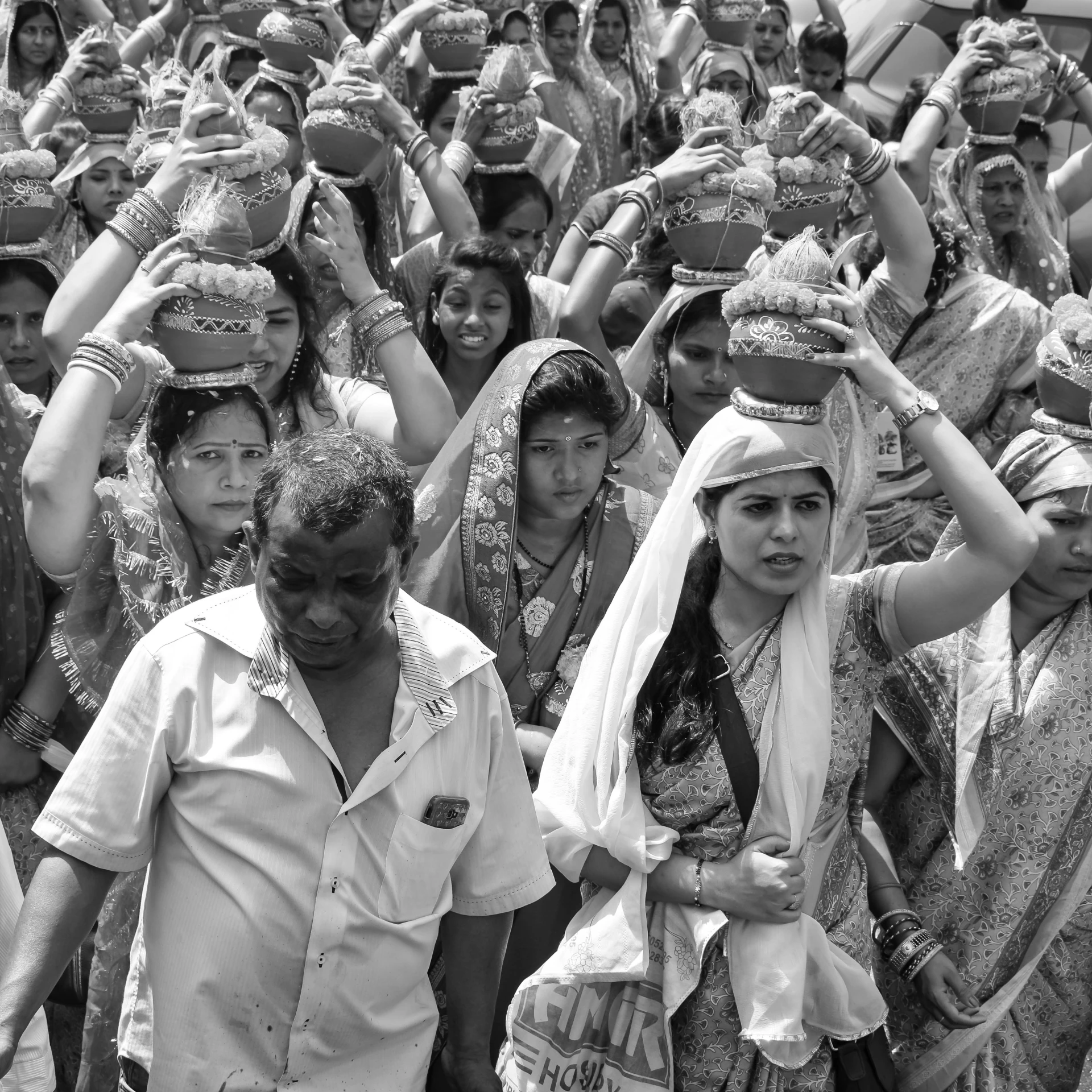 a crowd of people with a bride and groom