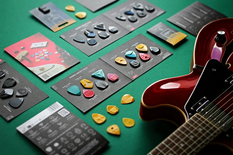 a guitar, a on and a book are on the table