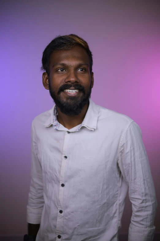 man with beard and white shirt looking at camera