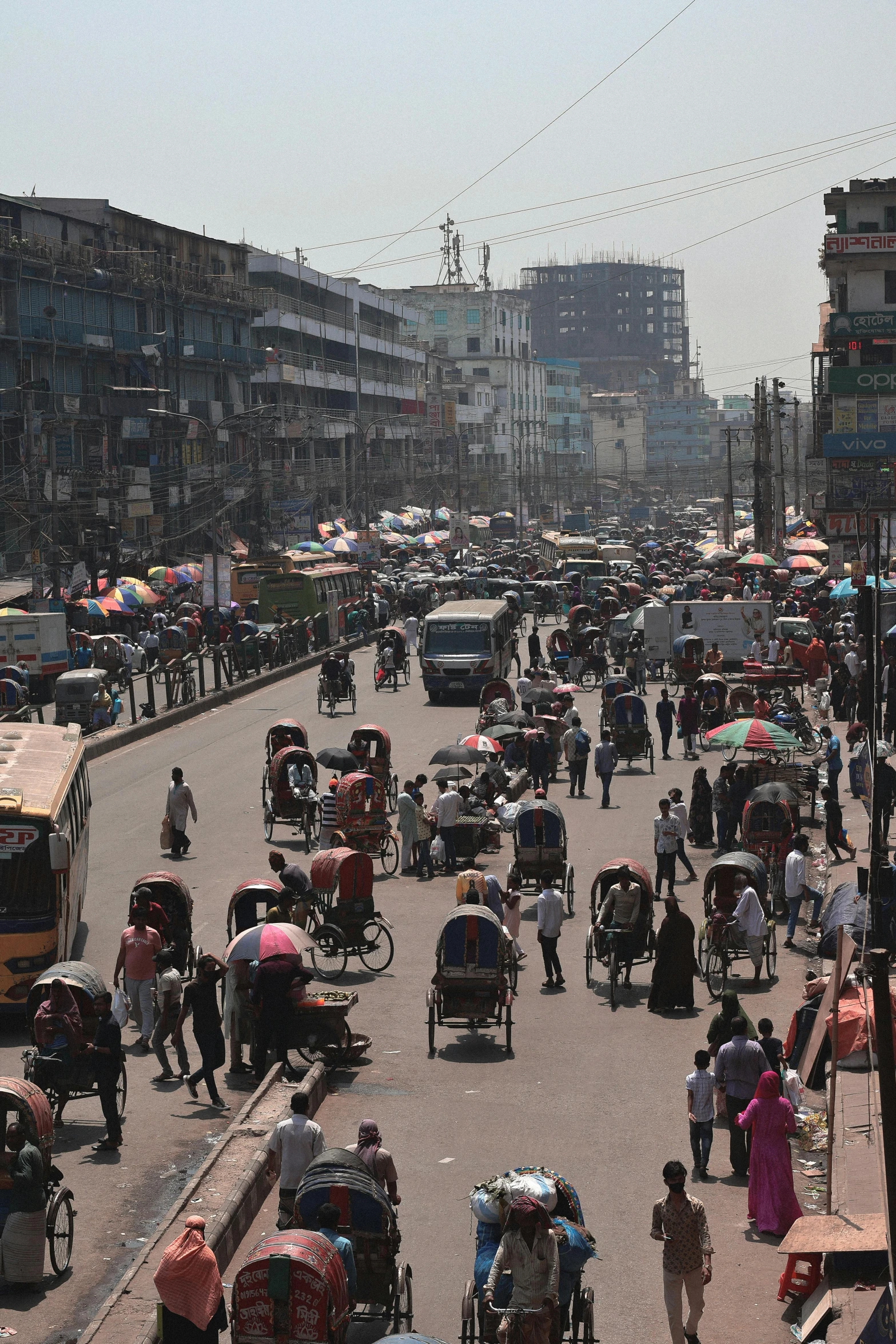 a busy street with large traffic with vehicles and people on it