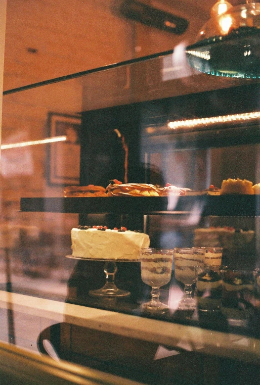 a window display with small glass dishes behind the case