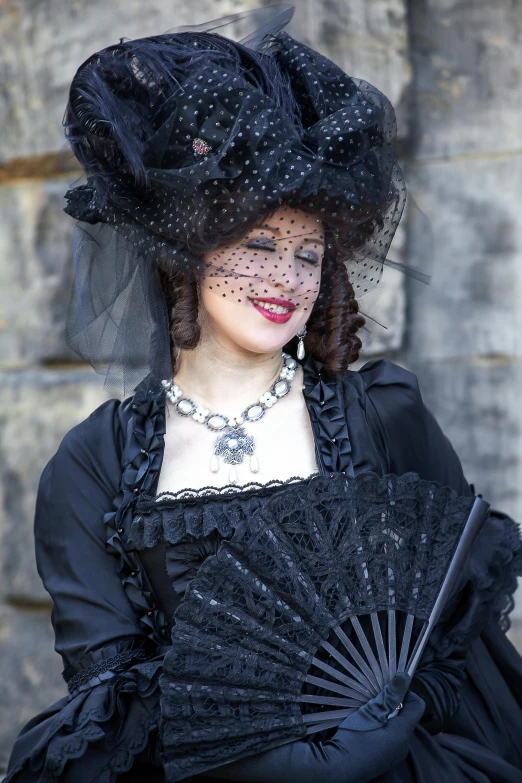 a woman with black gown and an umbrella