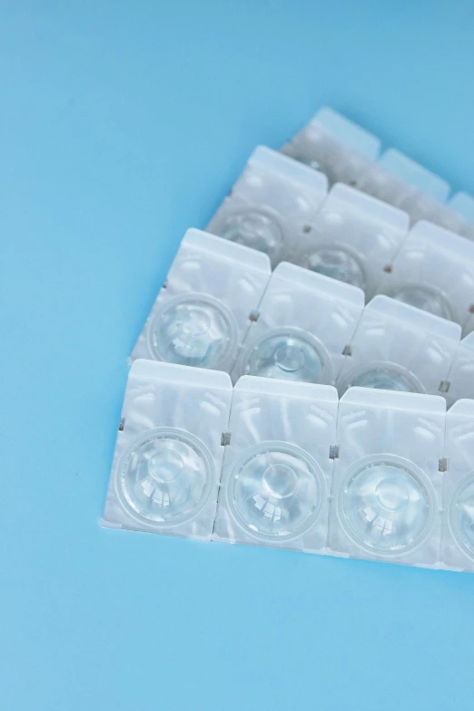 an empty pack of pills laying on top of a blue table