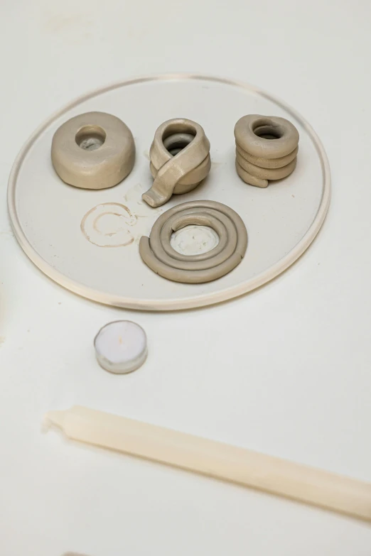 a round object that includes two doughnut holes, a spindle and a tape cutter