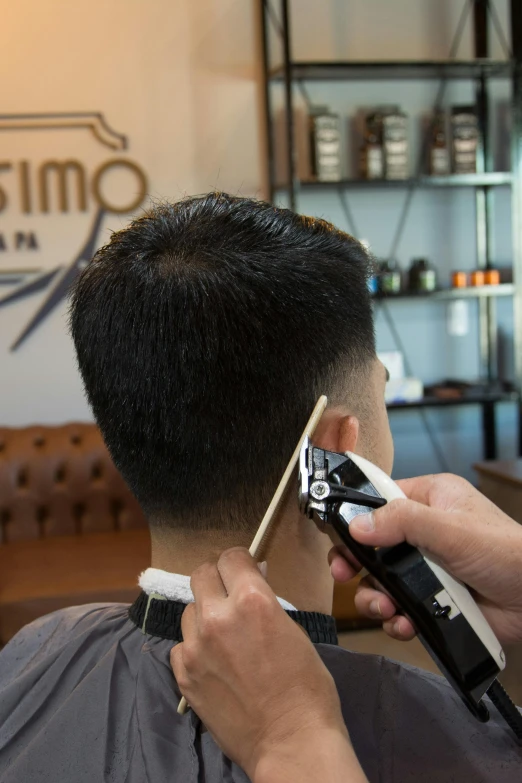 the man is  his hair and getting ready for the day